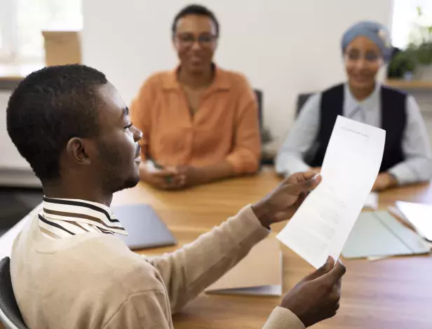 man-holding-contract-for-his-new-office-job-after-the-interview